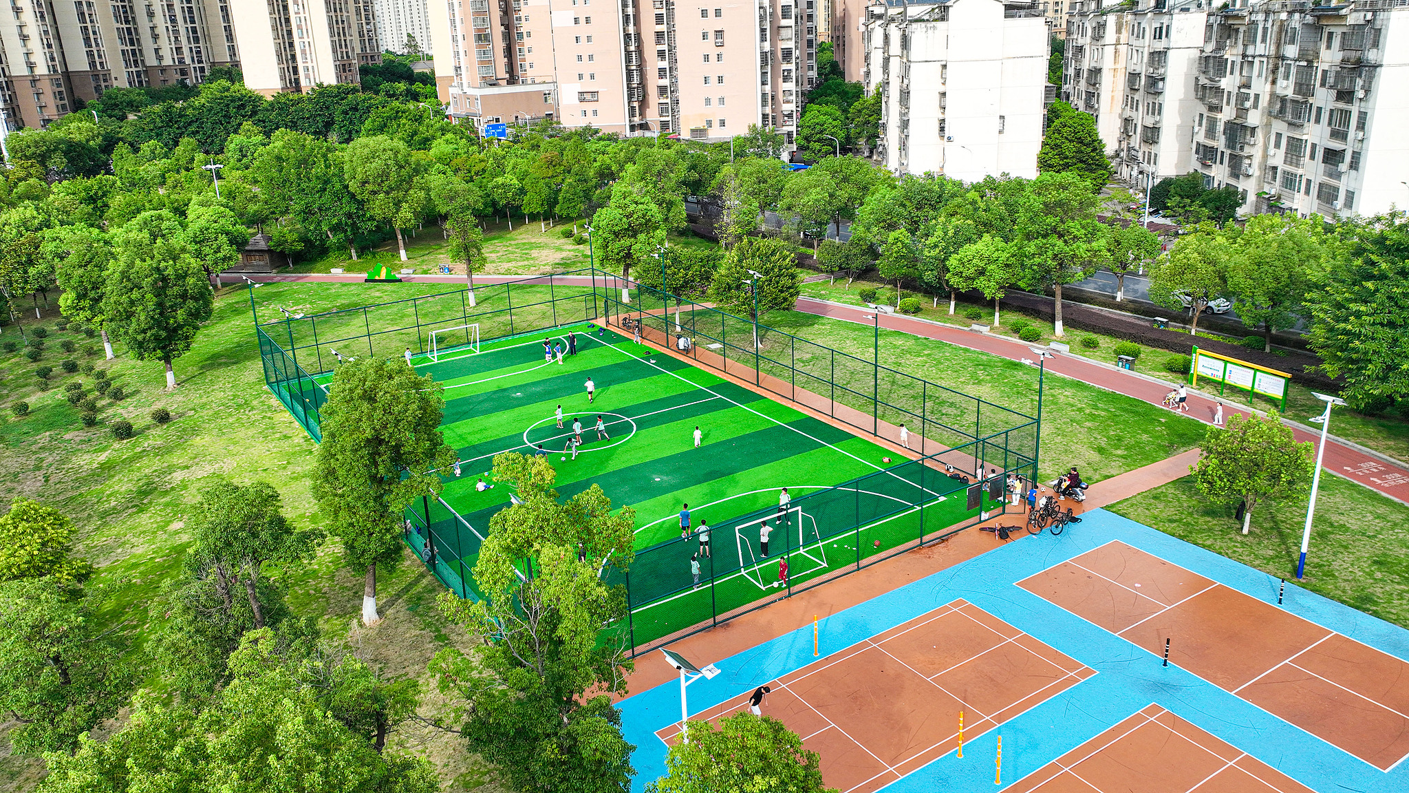 Residents play football on a pitch in a pocket park in Ganzhou City, east China's Jiangxi Province, June 30, 2026. /VCG