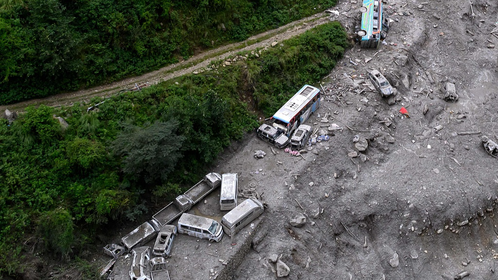An aerial view shows vehicles damaged and deluged in sludge in the aftermath of flash floods at Timure in Nepal's Rasuwa district, September 3, 2026. /VCG