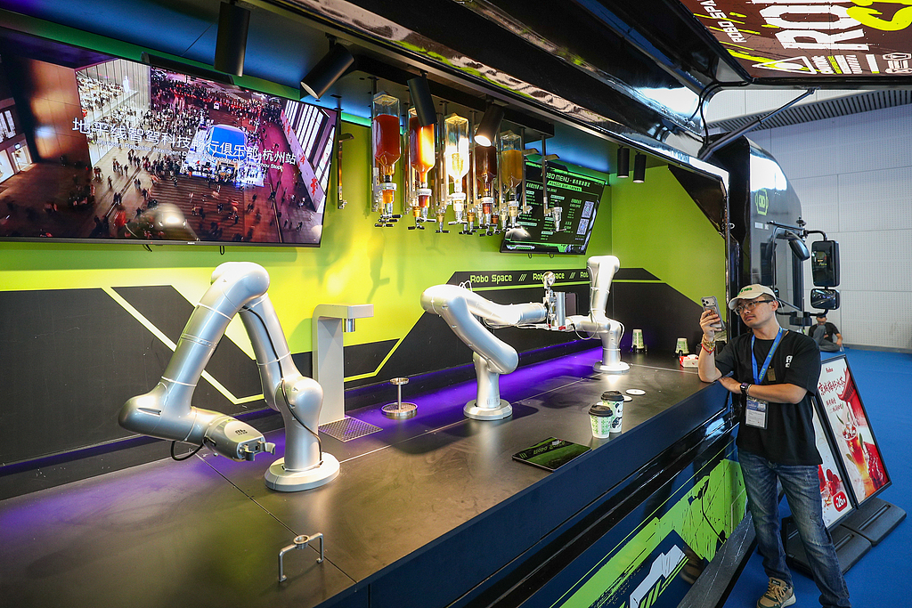 Visitors view a robot food truck displayed at the 2026 China Culture and Tourism Industries Expo on September 3, 2026, in Tianjin. /VCG