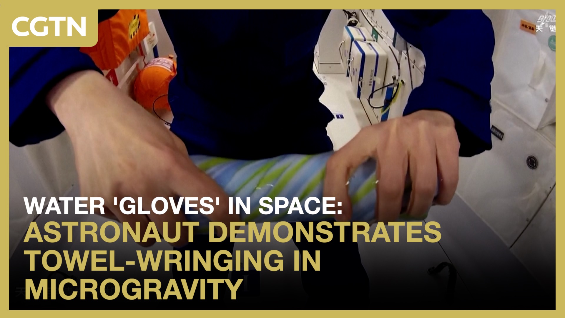 Astronaut demonstrates towel-wringing in microgravity