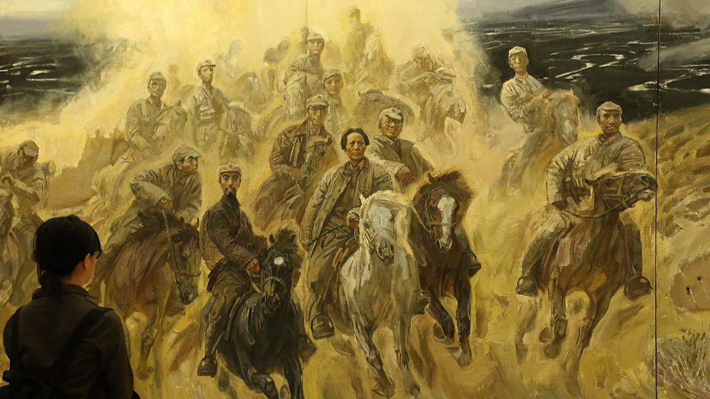 A visitor views an oil painting depicting the Chinese Red Army's Long March in Beijing, May 5, 2026. /VCG