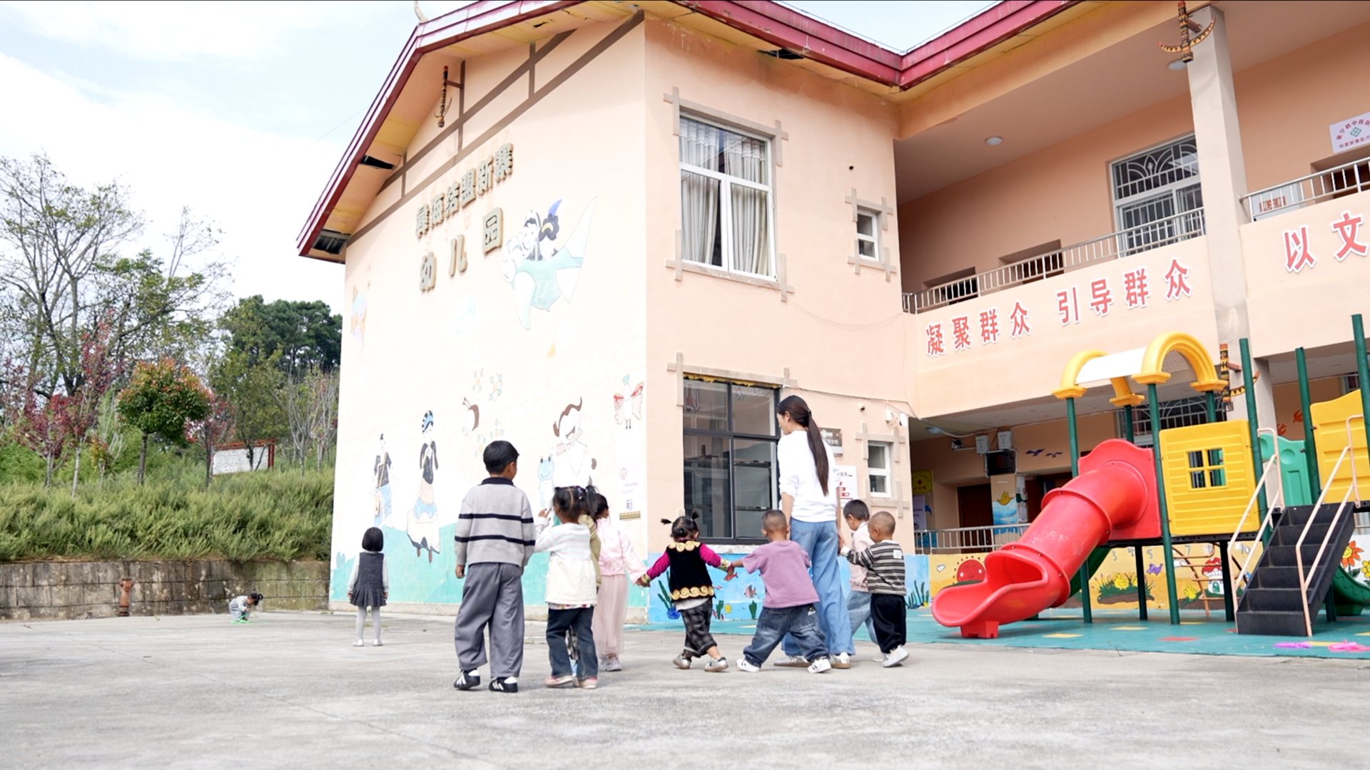 A teacher plays with children at a kindergarten in Yihai Village, Mianning County, Liangshan Yi Autonomous Prefecture, Sichuan Province, September 8, 2026. Zhang Yize/CGTN