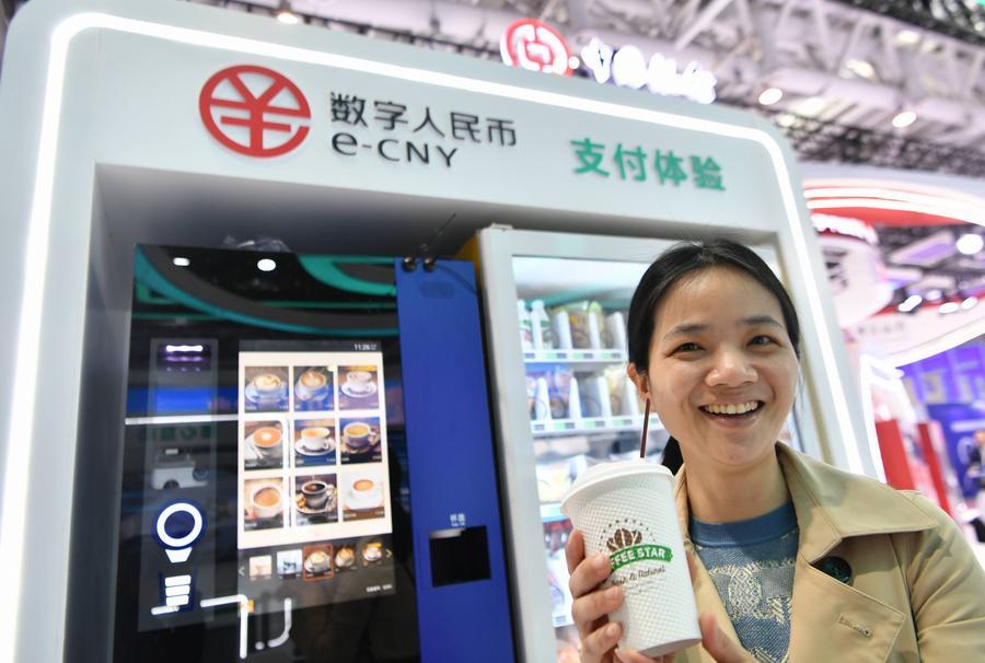 A visitor displays a cup of coffee purchased with China's digital yuan, or the e-CNY, at an exhibition of the 6th Digital China Summit in Fuzhou, southeast China's Fujian Province, April 26, 2023. /Xinhua