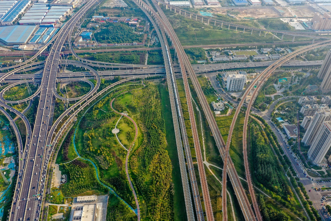 High-speed trains run through the greenery of Zhengdong New Area in Zhengzhou, Henan Province, China, on June 17, 2026. /VCG