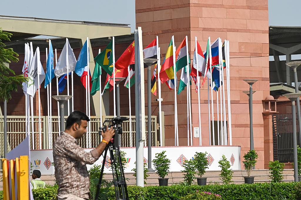 The flags of BRICS members and BRICS partner countries, along with flags of BRICS institutions, are seen fluttering together at the entrance of Bharat Mandapam, the 2026 BRICS Summit's venue, in New Delhi, India, on September 9, 2026. /VCG