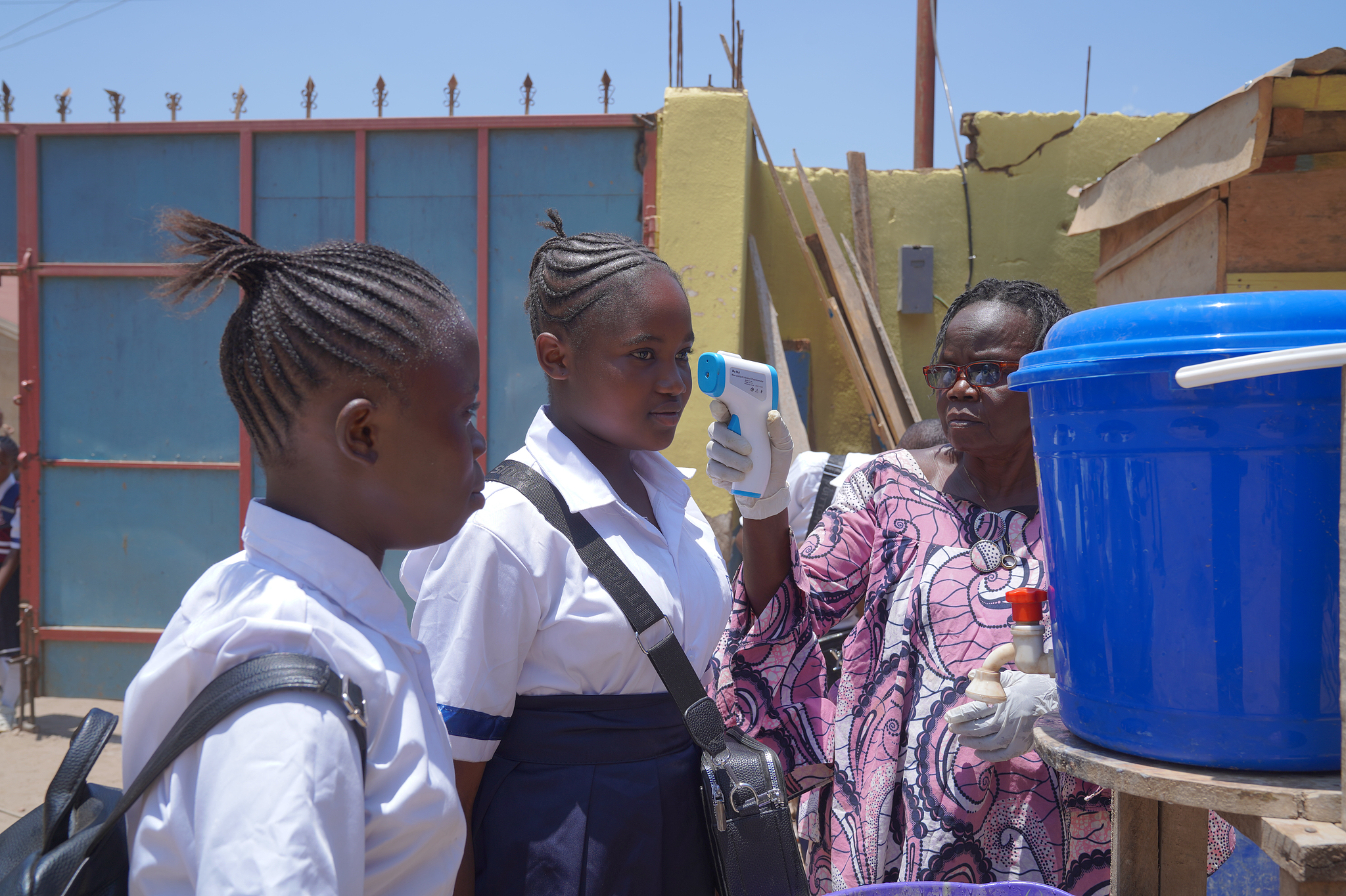 A school official checks students' temperatures as they enter school in the new school year amid the Ebola virus outbreak in Ituri Province, September 1st, 2026. /CFP