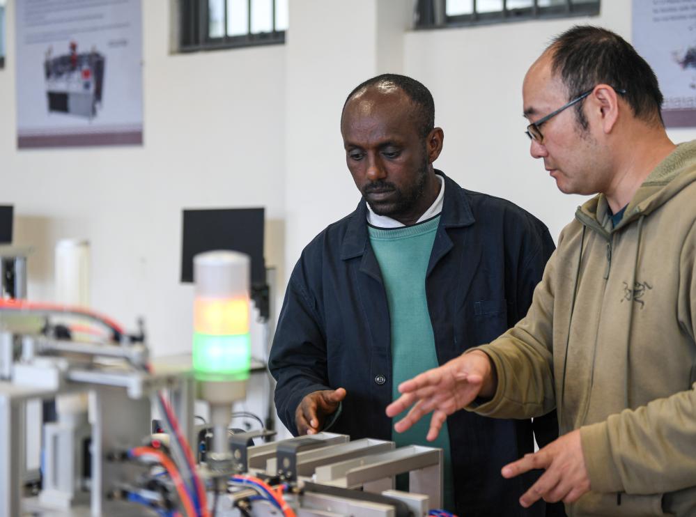 A Chinese head of a Luban Workshop talks with a local teacher at the Federal Technical and Vocational Training Institute in Addis Ababa, Ethiopia, February 15, 2024. /Xinhua
