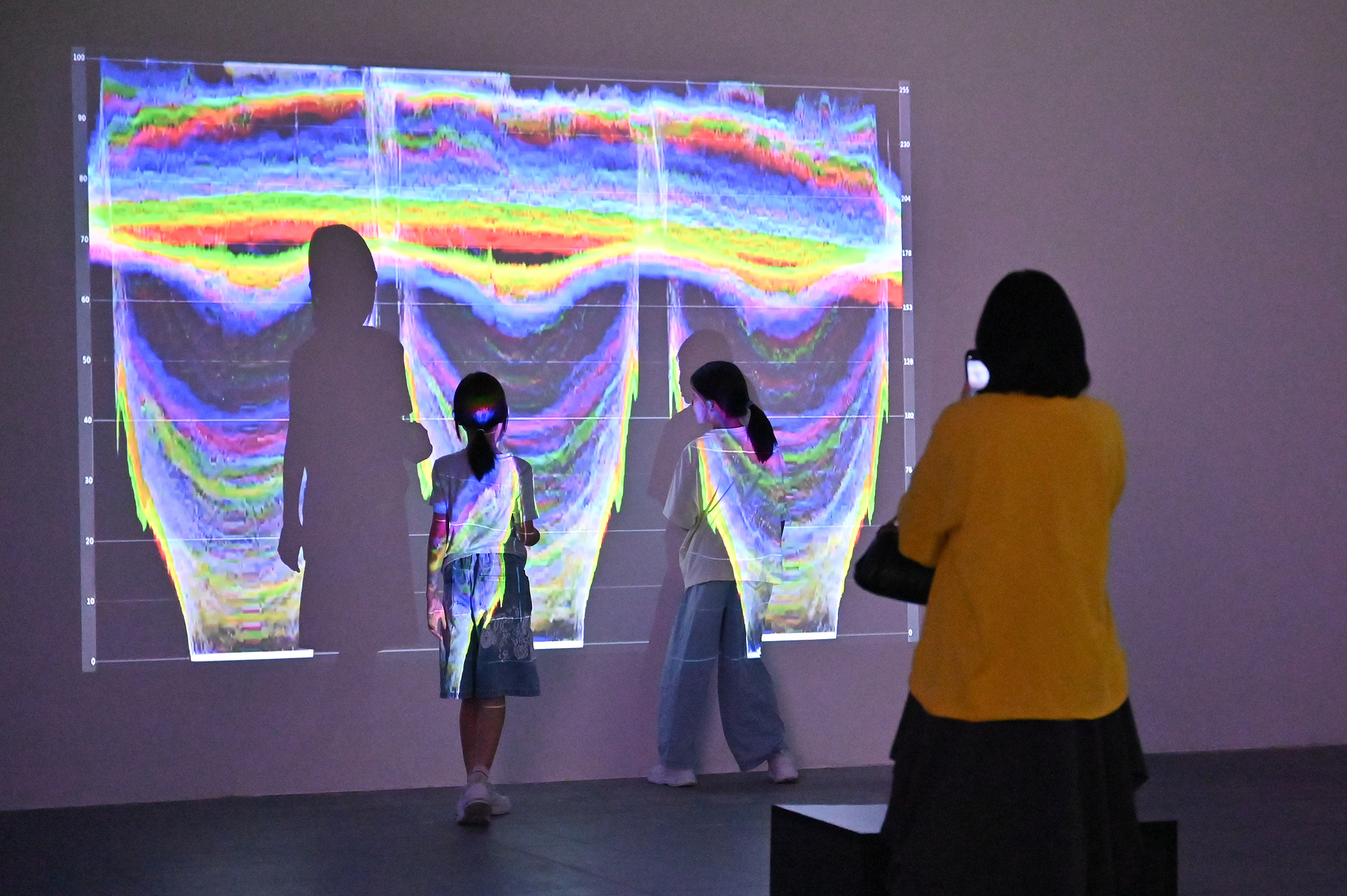 Visitors appreciate an exhibit at the 12th Euro-Asian Mediations Digital Art Biennale in Guangzhou, Guangdong Province, on September 13, 2026. /VCG