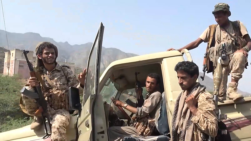 Houthi fighters gather around a vehicle at a seized camp during an offensive in the port city of Mokha, western coast of Yemen, September 13, 2026. /VCG 