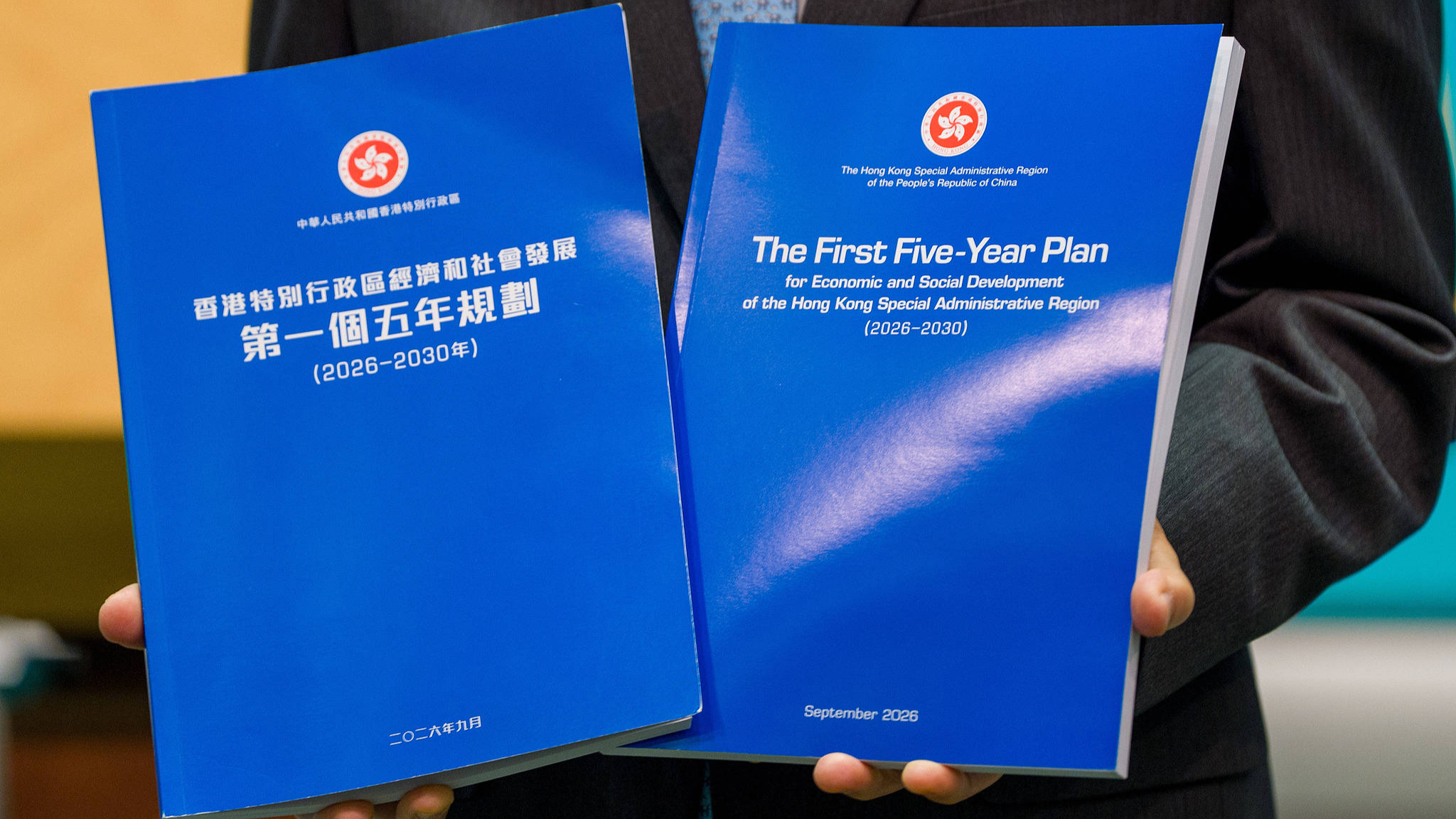 Hong Kong Chief Executive John Lee holding up the five-year plan booklet at a press conference before his executive council meeting on September 15, 2026, in Hong Kong Special Administrative Region (HKSAR), China. /CFP
