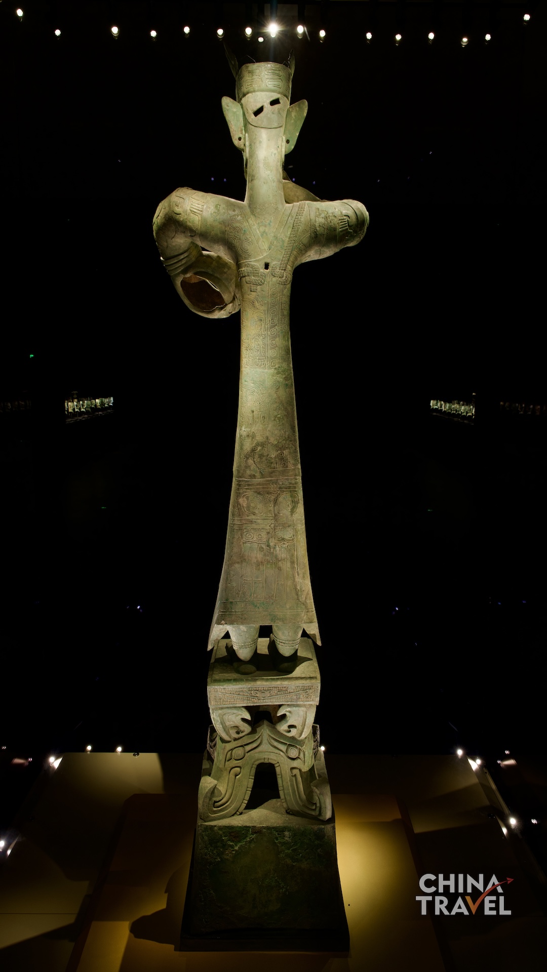 Full-length views present the Great Bronze Standing Figure as a monumental composition, uniting its tall body, circular hand gestures and richly decorated pedestal. /CGTN