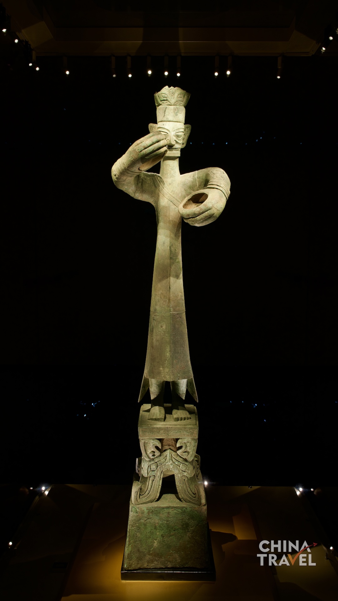 Full-length views present the Great Bronze Standing Figure as a monumental composition, uniting its tall body, circular hand gestures and richly decorated pedestal. /CGTN