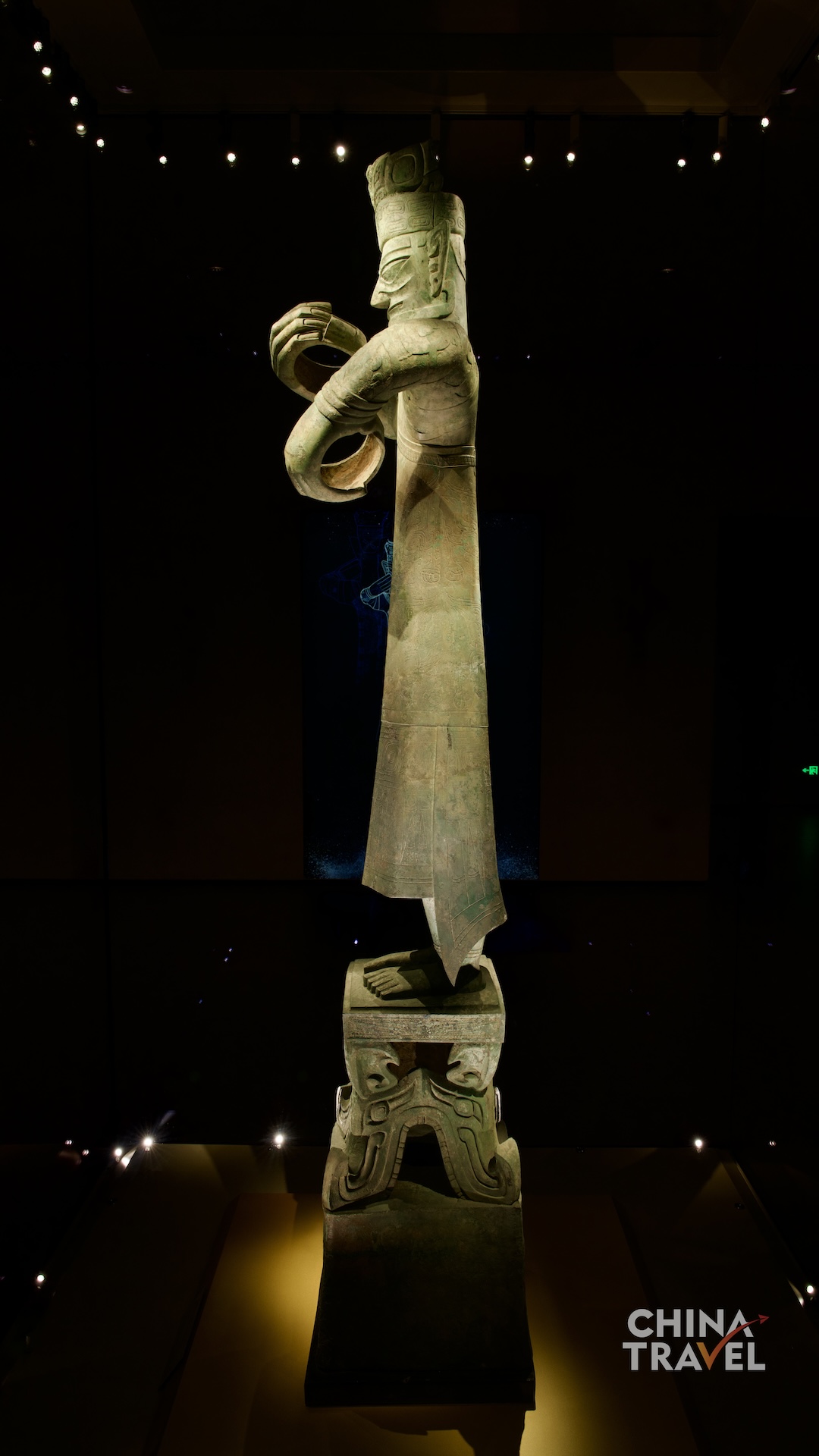 Full-length views present the Great Bronze Standing Figure as a monumental composition, uniting its tall body, circular hand gestures and richly decorated pedestal. /CGTN