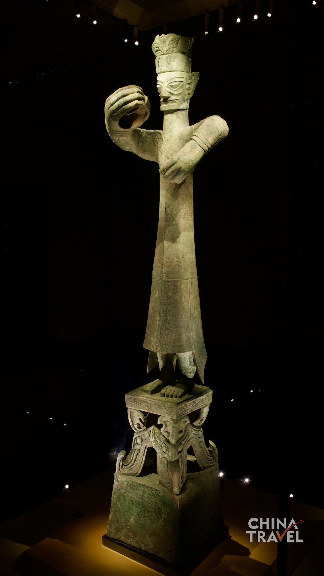 Full-length views present the Great Bronze Standing Figure as a monumental composition, uniting its tall body, circular hand gestures and richly decorated pedestal. /CGTN