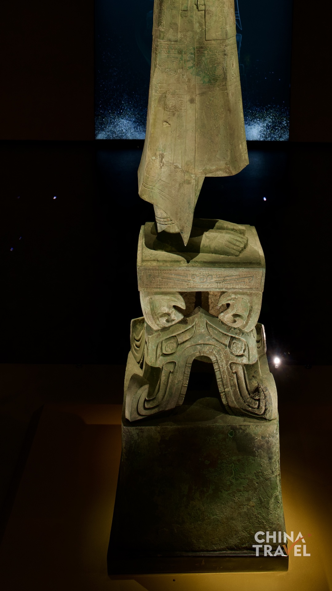 A low-angle detail reveals the long robe, bare feet and layered ornamentation of the pedestal. /CGTN