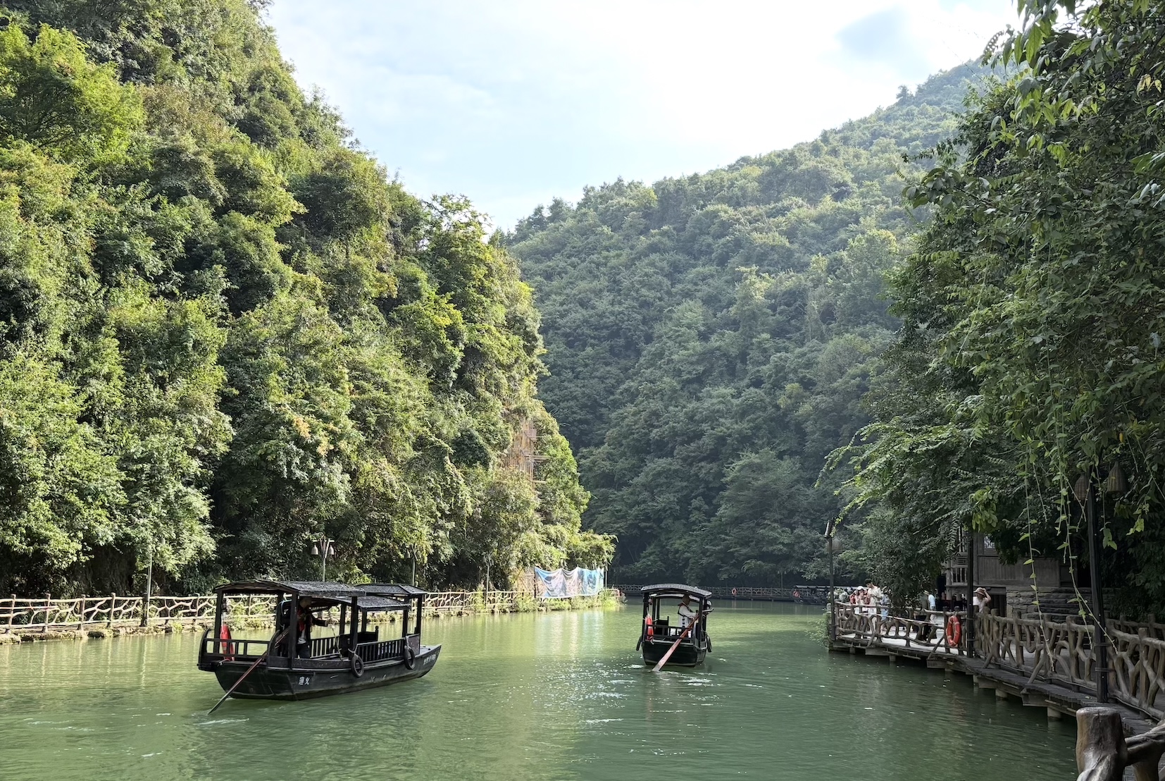 Wooden sculling boats travel along the Wujiang River in Guizhou, China. /CGTN