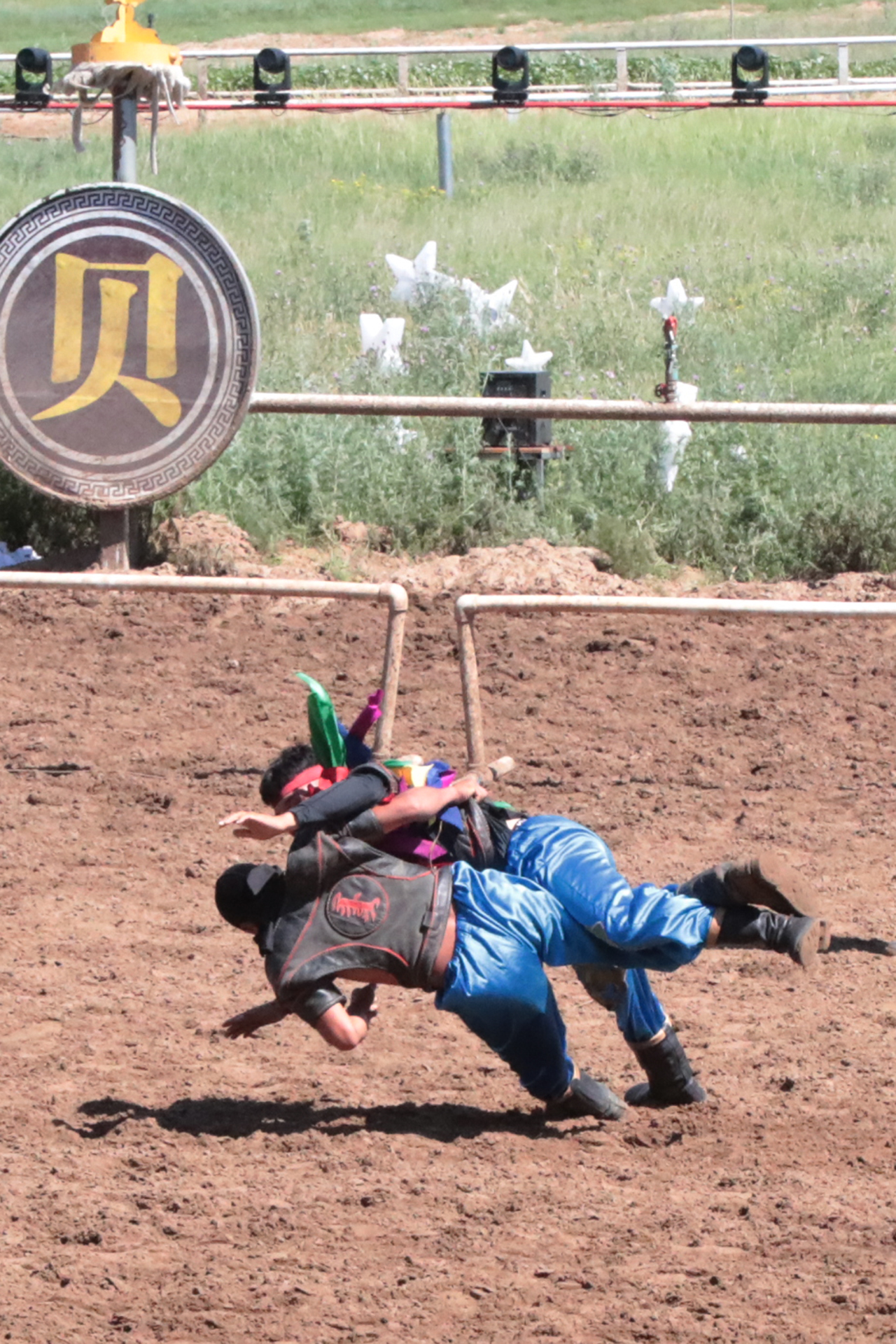 Two wrestlers compete in a Mongolian wrestling match during 