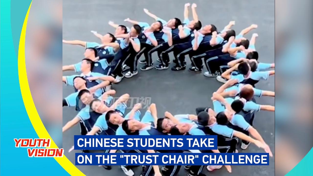 Chinese students take on the 'trust chair' challenge
