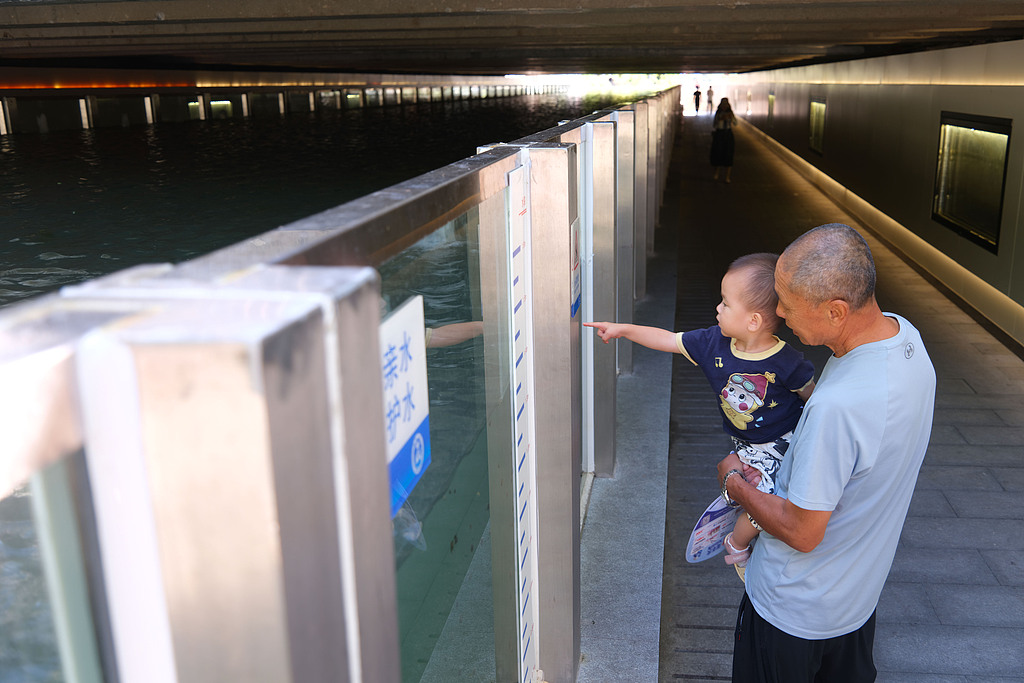 Residents visit the underwater glass walkway beneath the Jishuitan Bridge in Beijing on September 1, 2026. /VCG