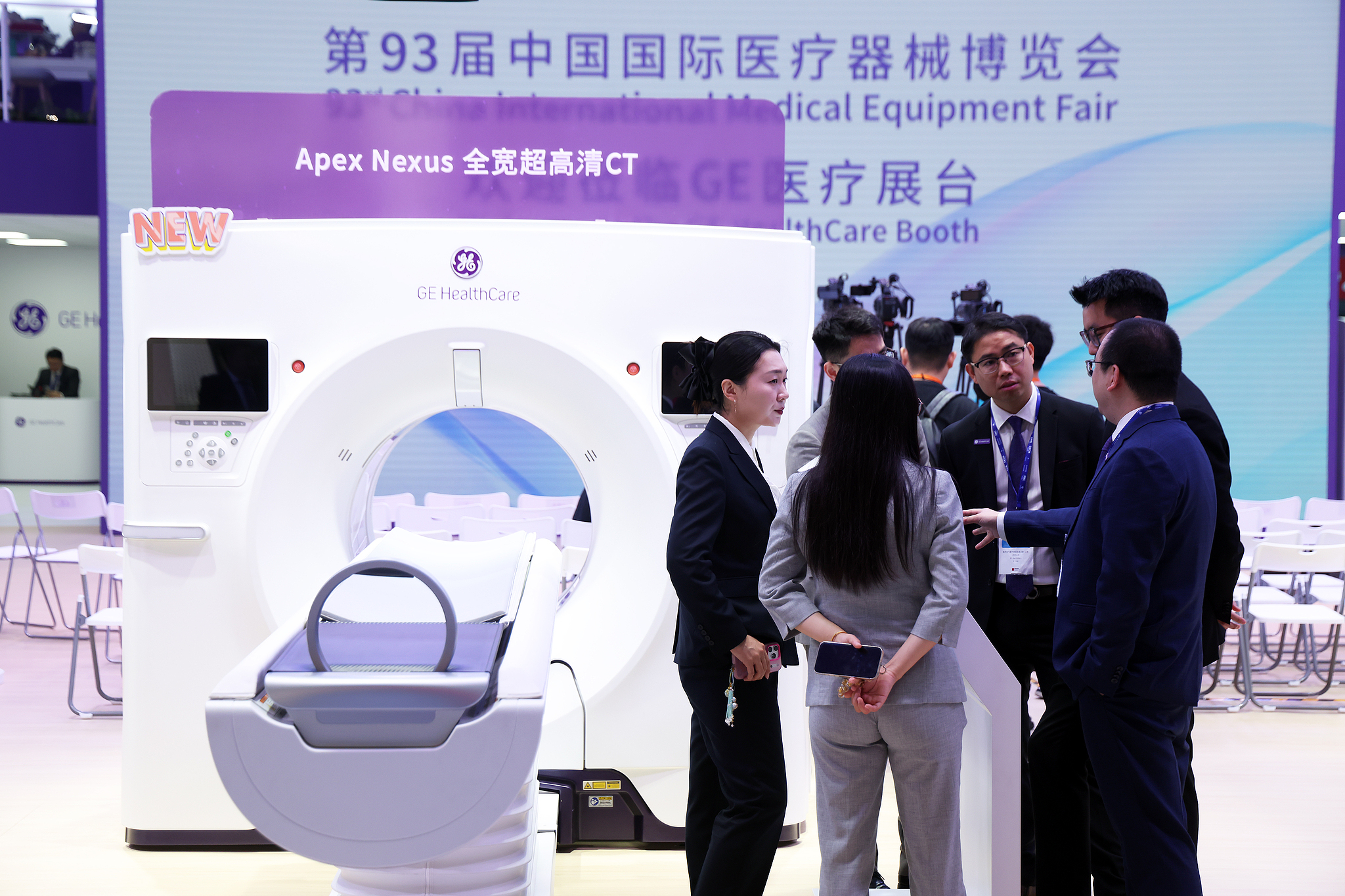 Exhibitors from China and overseas engage in discussions beside medical device exhibits in Shanghai, China, April 10, 2026. /CFP 
