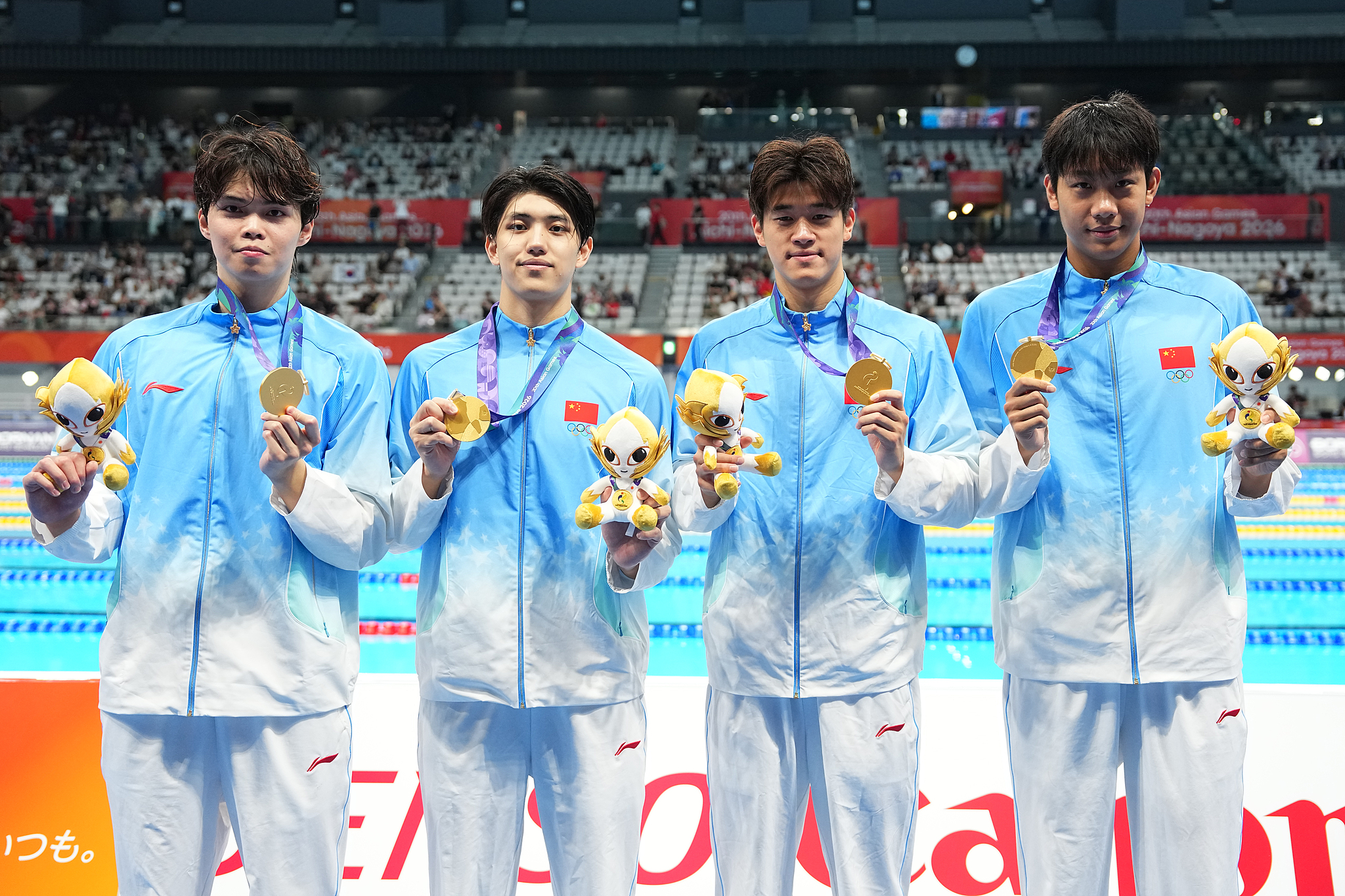 L-R: China's Xu Haibo, Fei Liwei, Pan Zhanle and Zhang Zhanshuo pose with their gold medals after winning the men's 4×200-meter freestyle relay final at the 2026 Aichi-Nagoya Asian Games in Tokyo, Japan, September 21, 2026. /VCG
