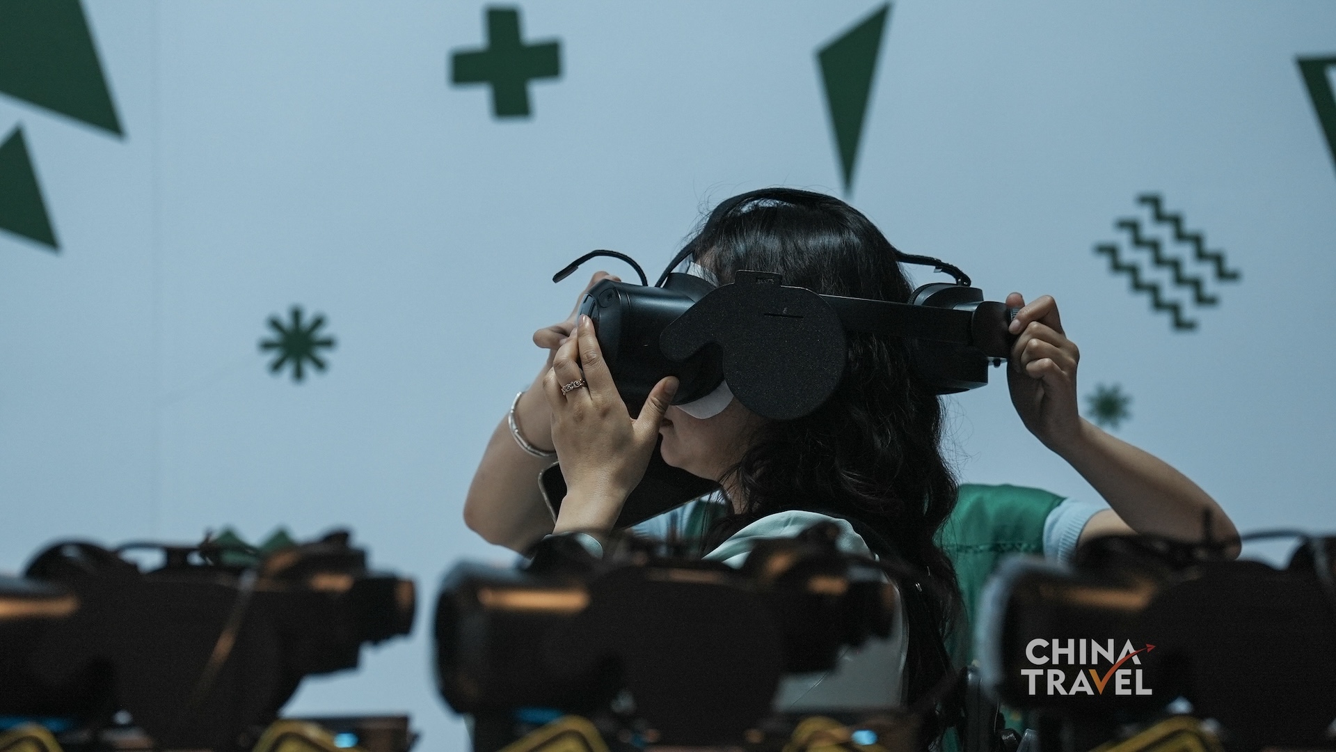 Visitors adjust headsets, enter the tracked room and use physical gestures to interact with the shared virtual environment at the new Sanxingdui Museum in Guanghan, Sichuan Province. /CGTN