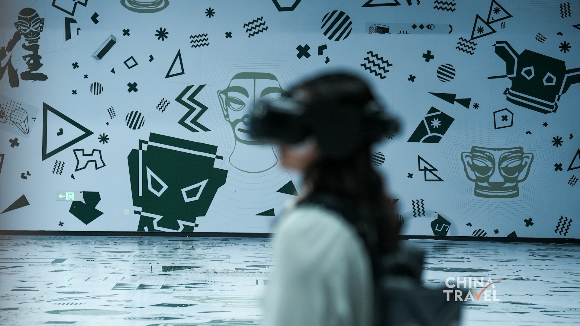 Visitors adjust headsets, enter the tracked room and use physical gestures to interact with the shared virtual environment at the new Sanxingdui Museum in Guanghan, Sichuan Province. /CGTN