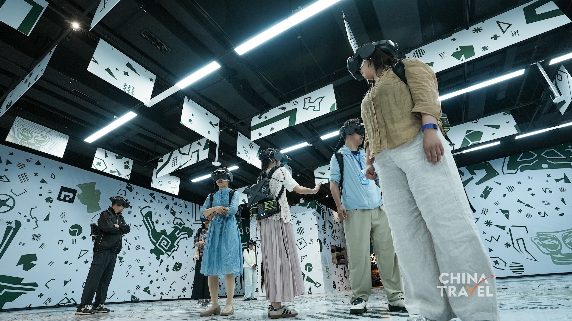 Wide views show multiple participants moving independently within one mapped play area supported by headsets and backpack computers at the new Sanxingdui Museum in Guanghan, Sichuan Province. /CGTN