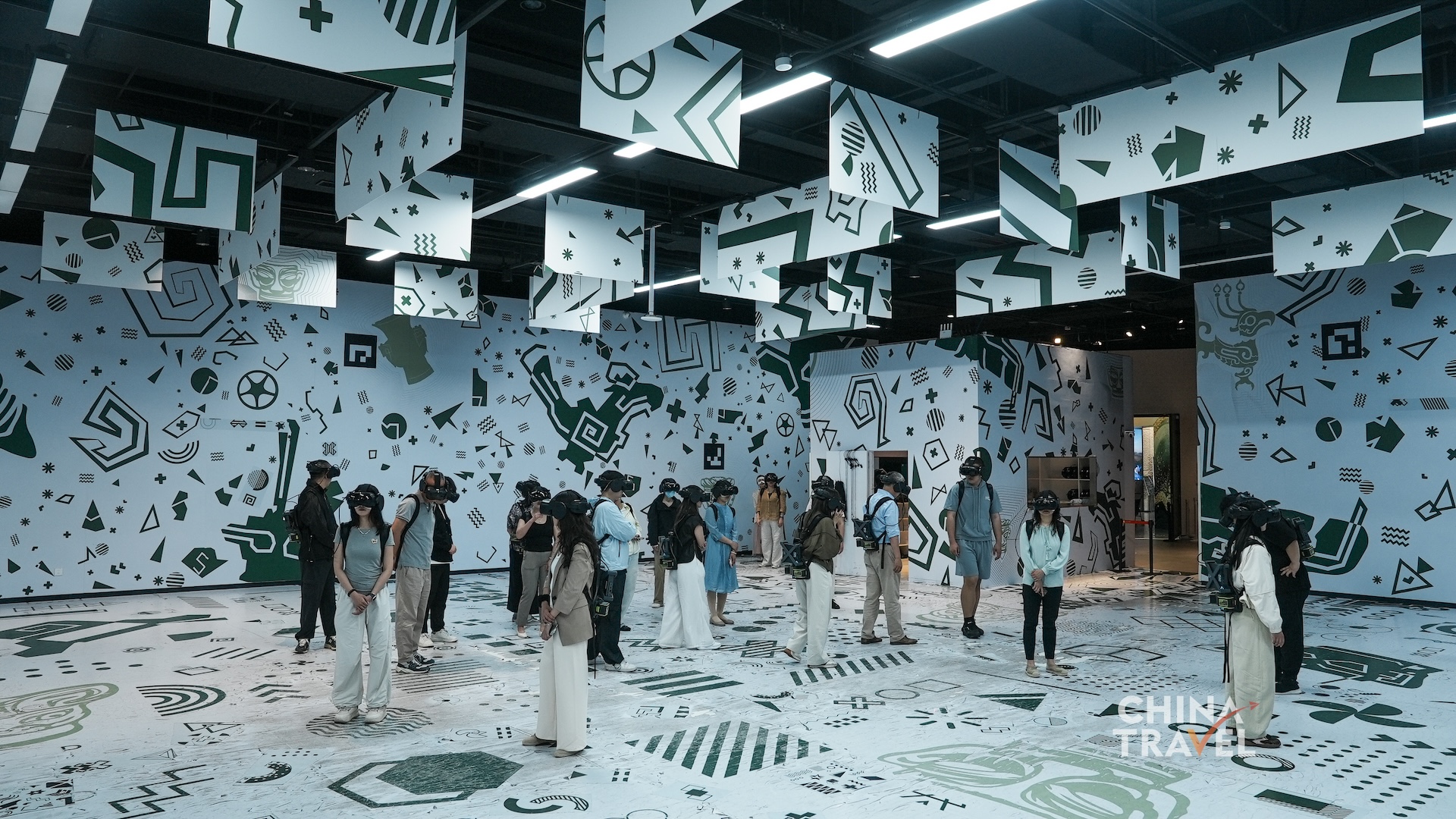Wide views show multiple participants moving independently within one mapped play area supported by headsets and backpack computers at the new Sanxingdui Museum in Guanghan, Sichuan Province. /CGTN