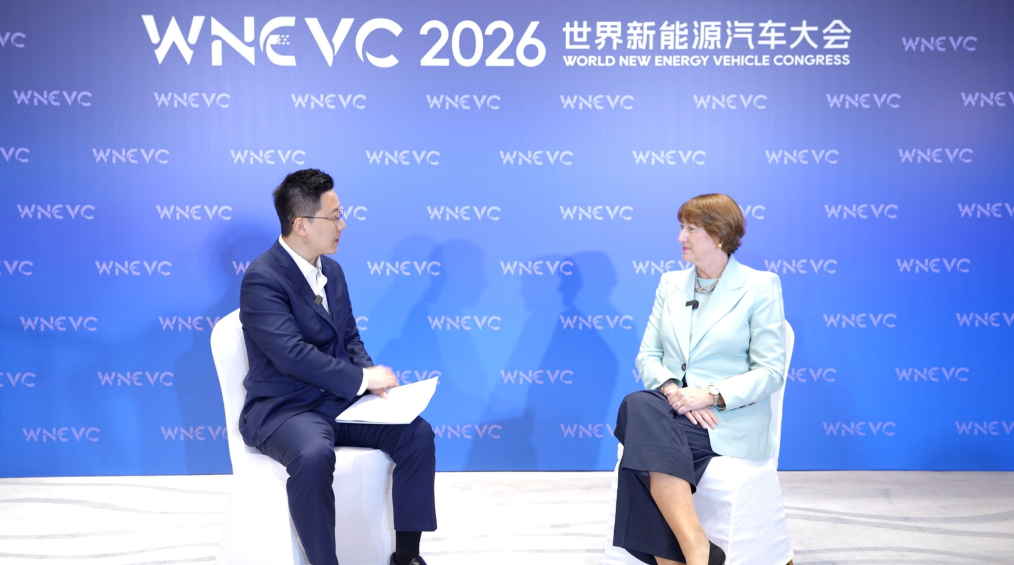 CGTN anchor Michael G. Wang (L) speaks with Hildegard Mueller (R), president of the German Association of the Automotive Industry, during the 2026 World New Energy Vehicle Congress in Haikou, Hainan Province, China, September 22, 2026. /WNEVC