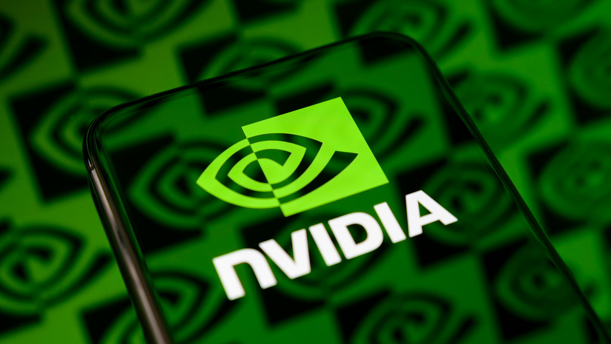 The Nvidia logo is displayed on a smartphone screen placed on a reflective surface onto which a multitude of the company's icons are projected, in Creteil, France, May 20, 2026. /VCG
