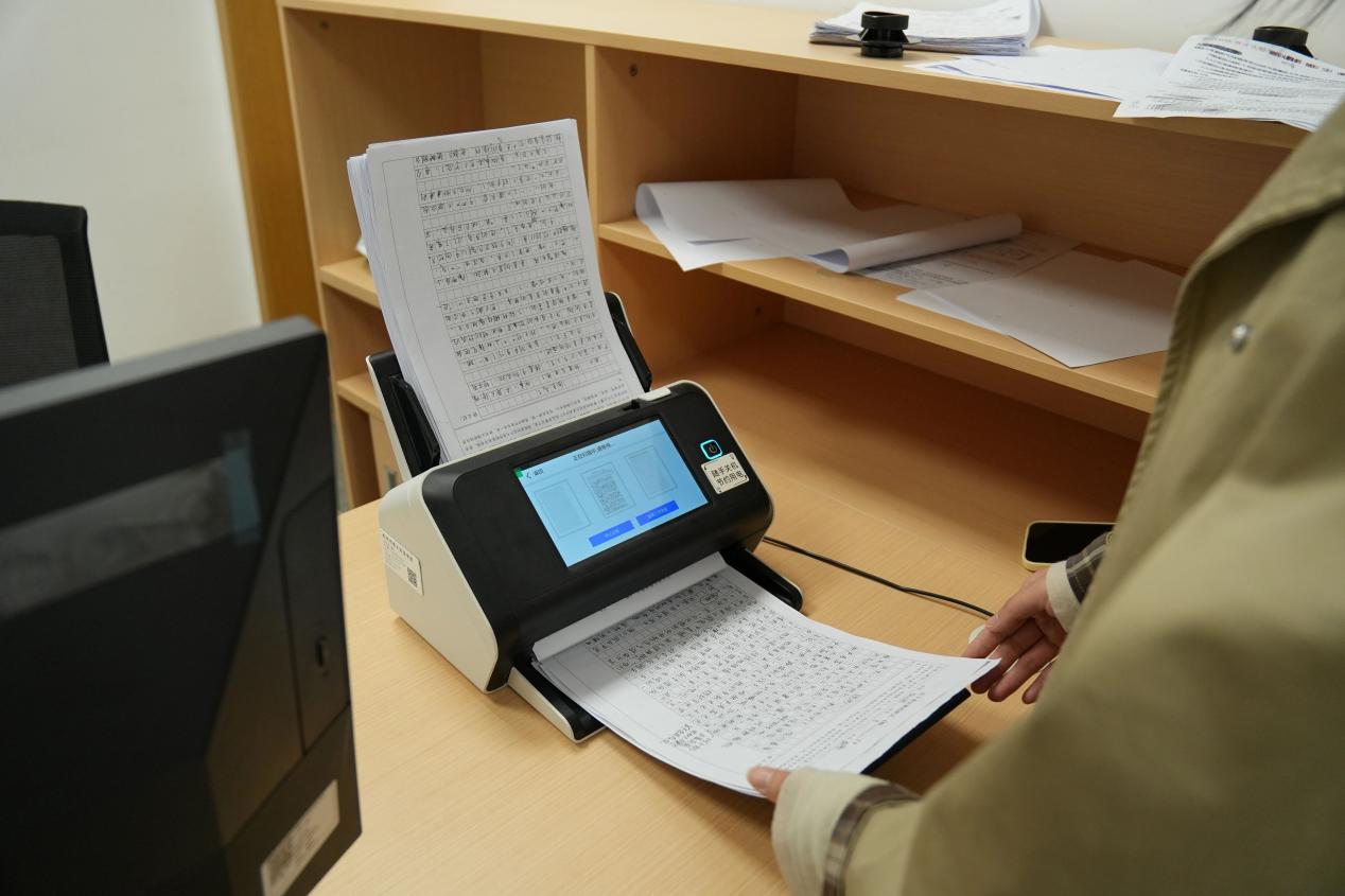 Teachers scan assignments with AI-powered grading devices, Hangzhou Yucai Experimental School.