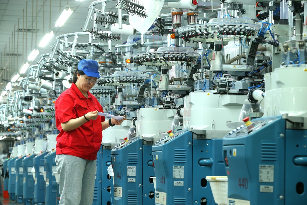 Workers operate an automated production line making socks for export in Qingdao, Shandong Province, September 16, 2026. /VCG