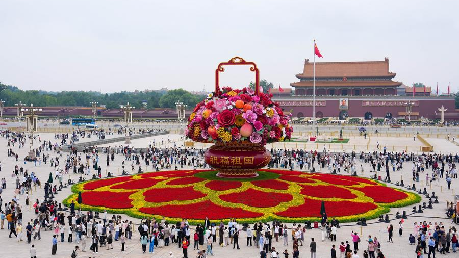 Visitors admire a giant floral basket installation ahead of celebrations to mark the 77th year of the People’s Republic of China at Tiananmen Square in Beijing, China, September 25, 2026. /Xinhua