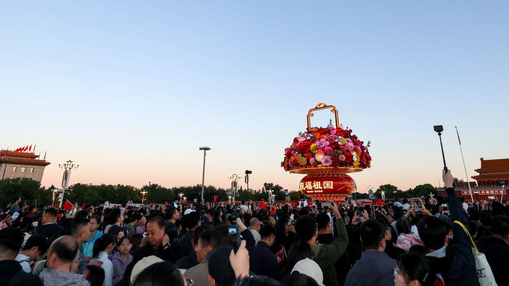 People attend a flag-raising ceremony marking the 77th anniversary of the founding of the People's Republic of China at Tiananmen Square in Beijing, capital of China, October 1, 2026. /Xinhua