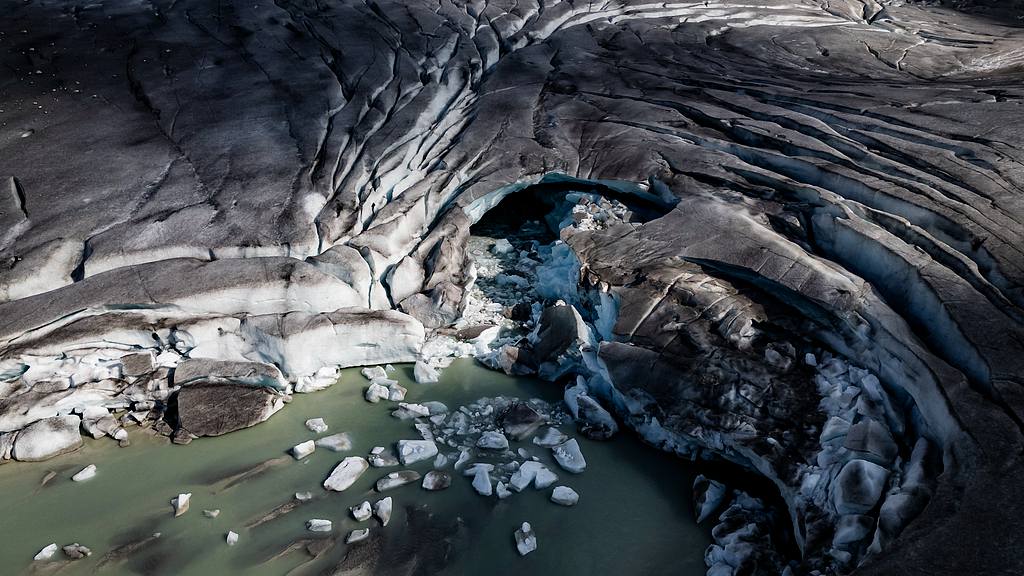 An aerial view of the tongue of the Rhone Glacier shows a hole formed by melting ice, Switzerland, July 16, 2026. /VCG