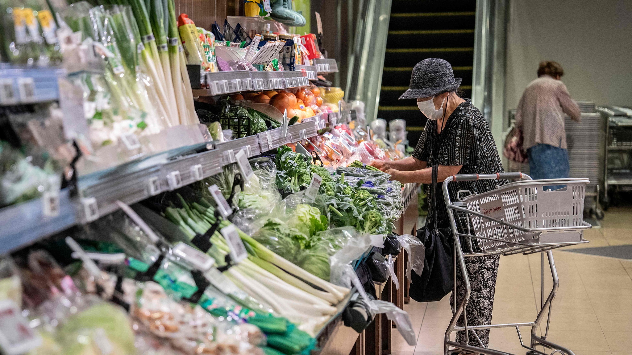 A customer shops for groceries at a supermarket in Tokyo on July 24, 2026. /VCG