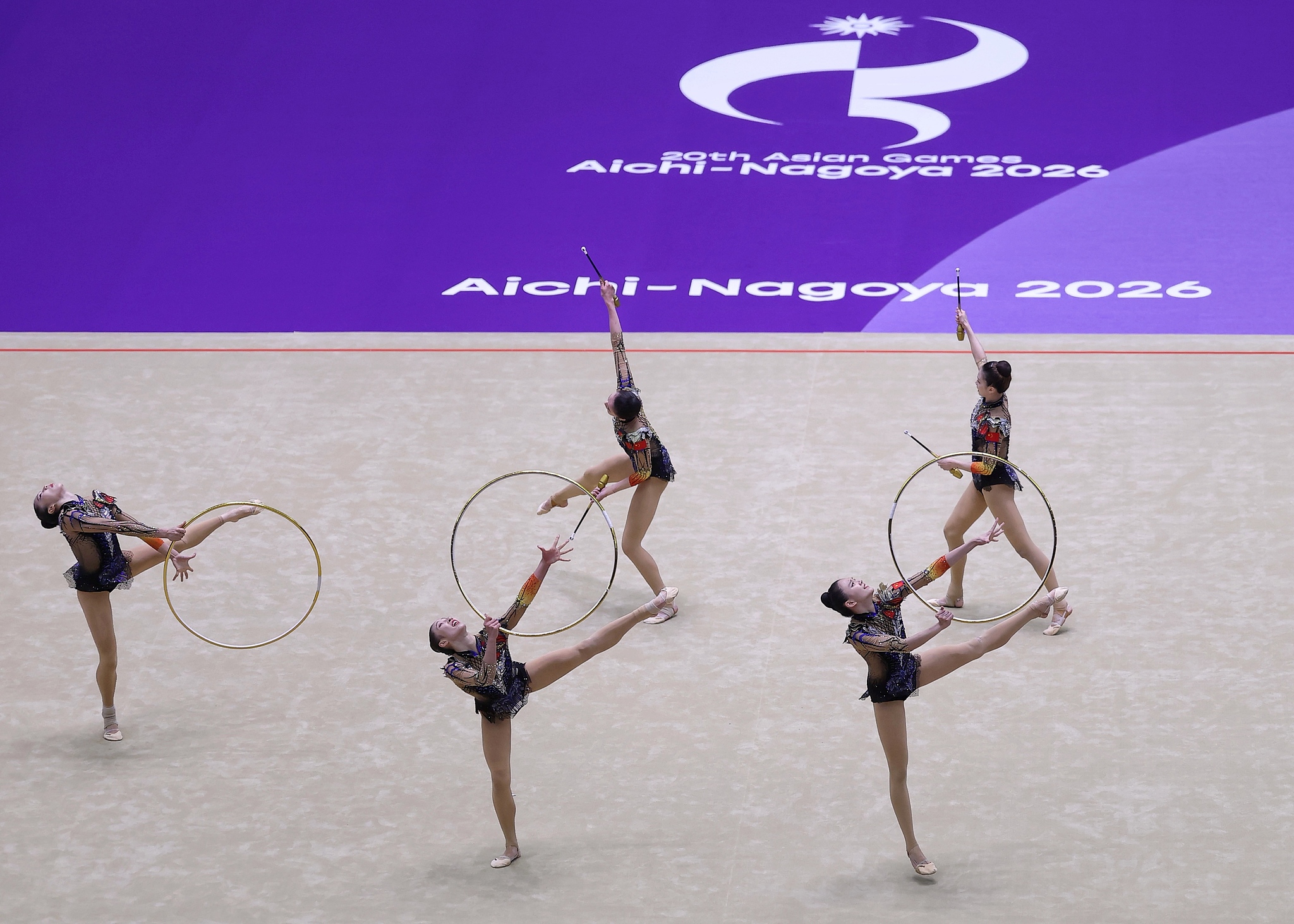 China's Xinyi Ding, Miaoting Liu, Yanzhu Pu, Lanjing Wang and Xinyi Zhang compete in the three hoops and two clubs event at the 2026 Asian Games in Nagoya, Japan, October 3, 2026. /VCG