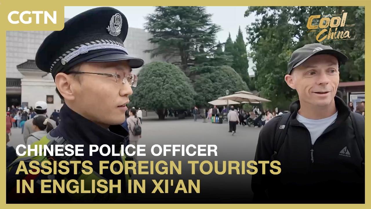 Chinese police officer assists foreign tourists in English in Xi'an
