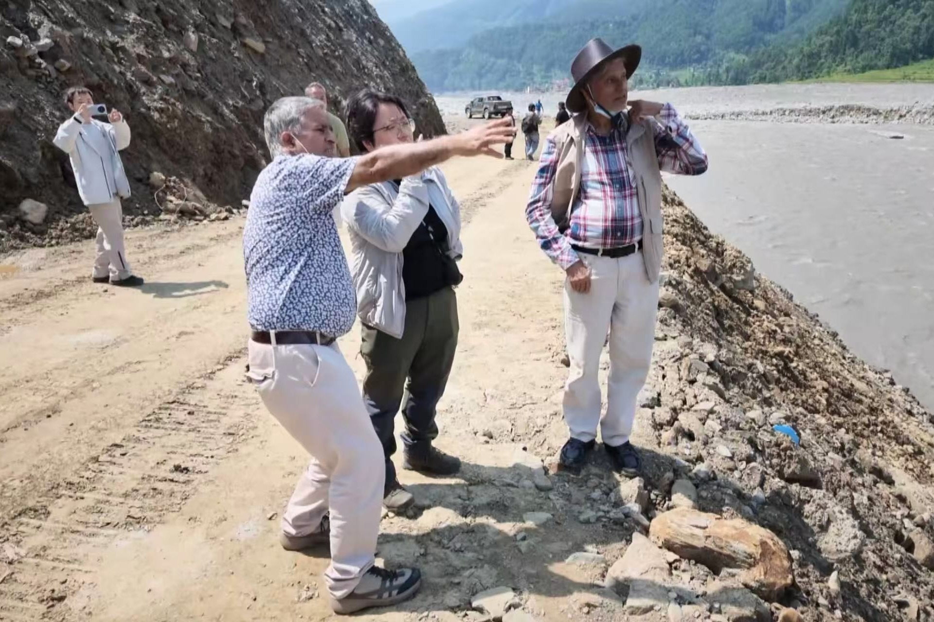 Members of a joint disaster survey team inspect a riverbank in Nepal. /CMG