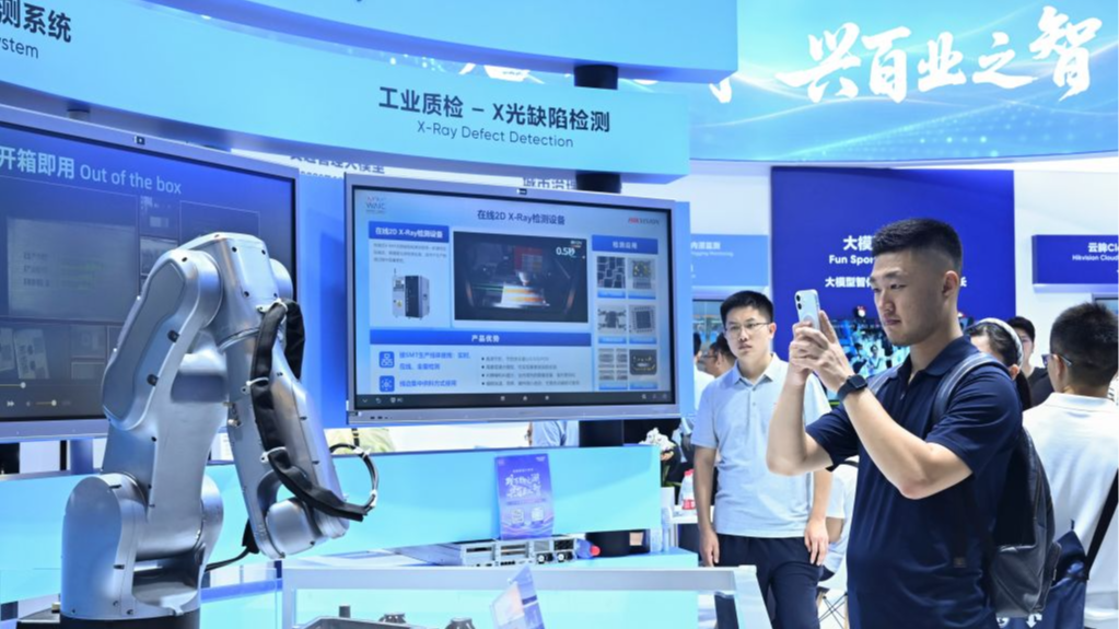A visitor takes photos of a robot during the 2026 World AI Conference and High-Level Meeting on Global AI Governance in Shanghai, China, July 19, 2026. /Xinhua