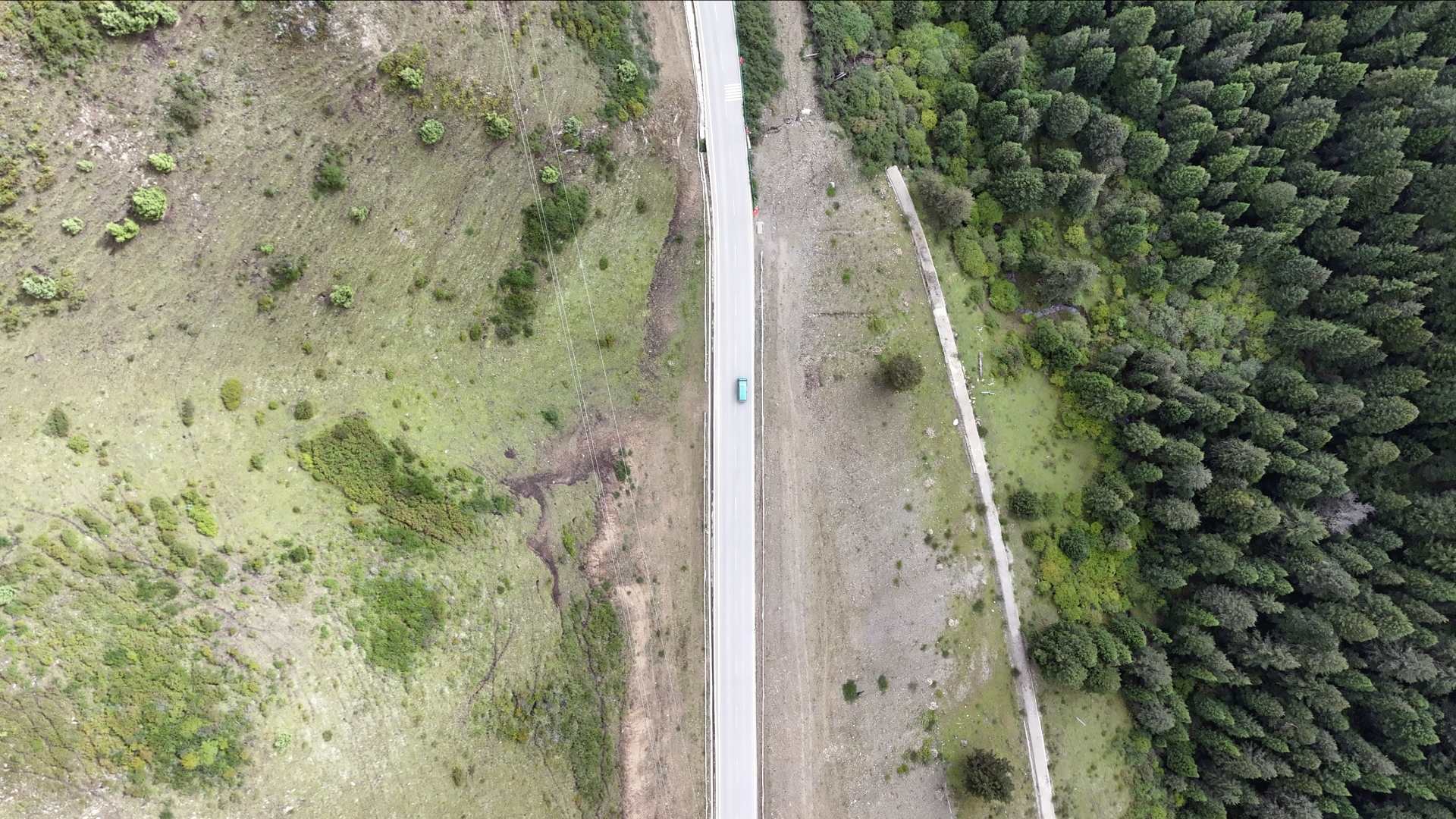 Lhalung Dorje drives on a newly-built concrete road in the mountains of Ruoergai County, Aba Tibetan-Qiang Autonomous Prefecture, southwest China's Sichuan Province, Sep. 17, 2026. Zhang Kai/ CGTN