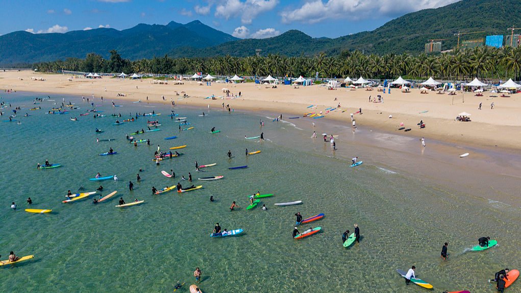 Tourists enjoy surfing in Wanning, south China's Hainan Province, October 3, 2026. /VCG