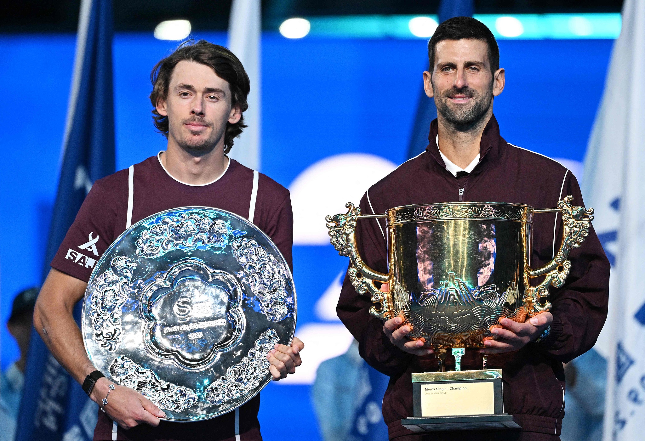 China Open champion Novak Djokovic of Serbia (R) and runner-up Alex de Minaur of Australia display their trophies after the men's singles final in Beijing, China, October 6, 2026. /VCG