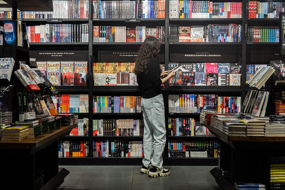 A reader browses books at a bookstore in Beijing, China, July 2024. /CGTN