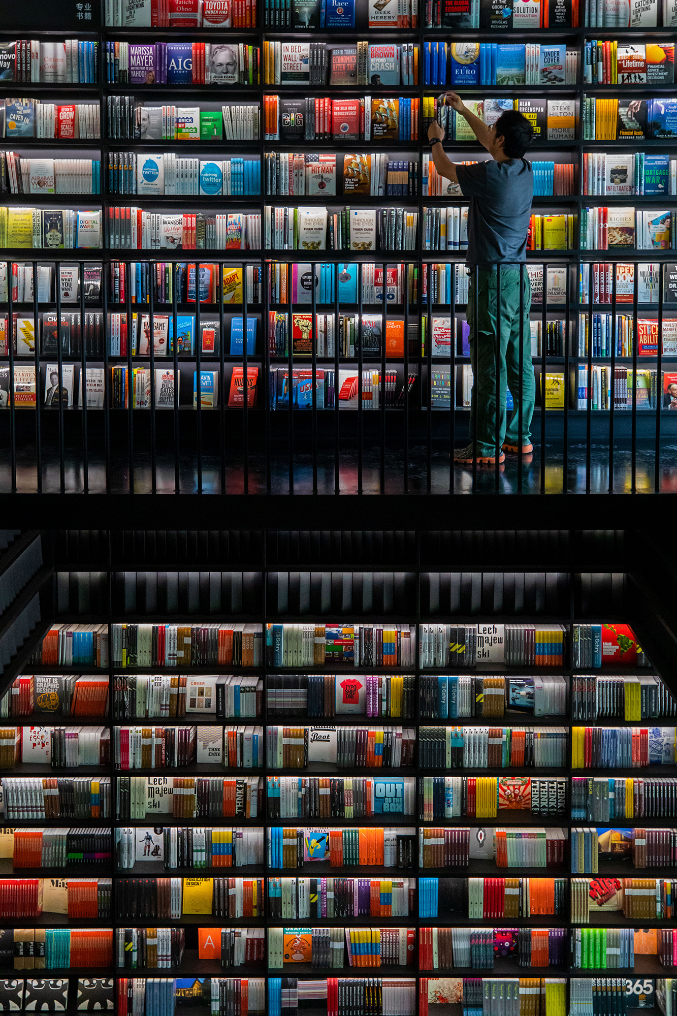 A reader browses books at a bookstore near Qianmen in Beijing, China, August 2019. /CGTN