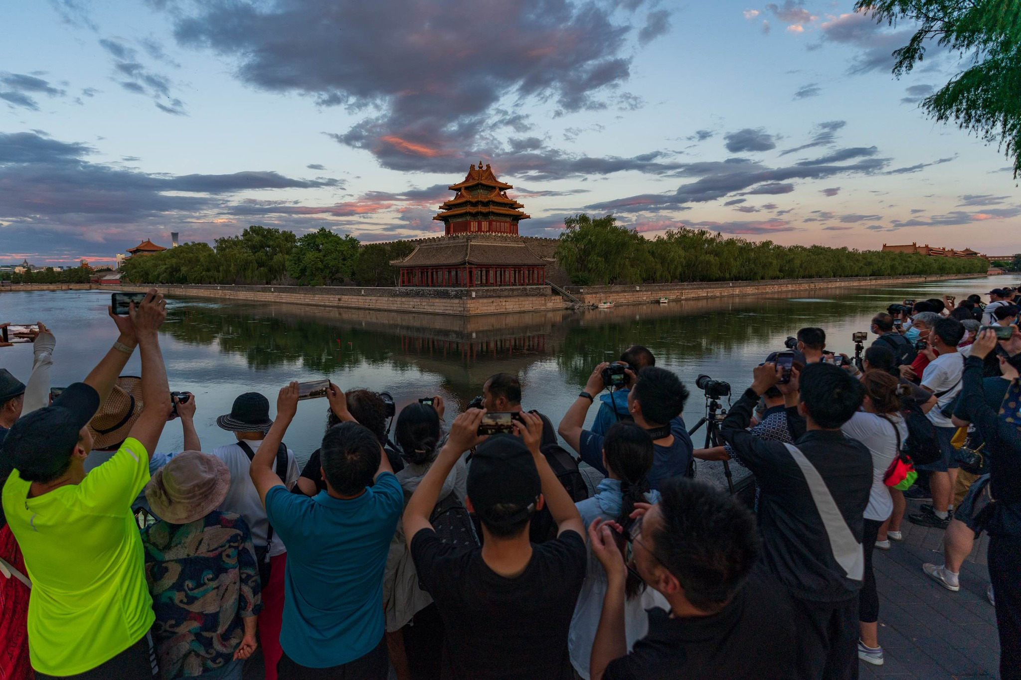 People photograph a corner tower of the Forbidden City in Beijing, China, September 2024. /CGTN