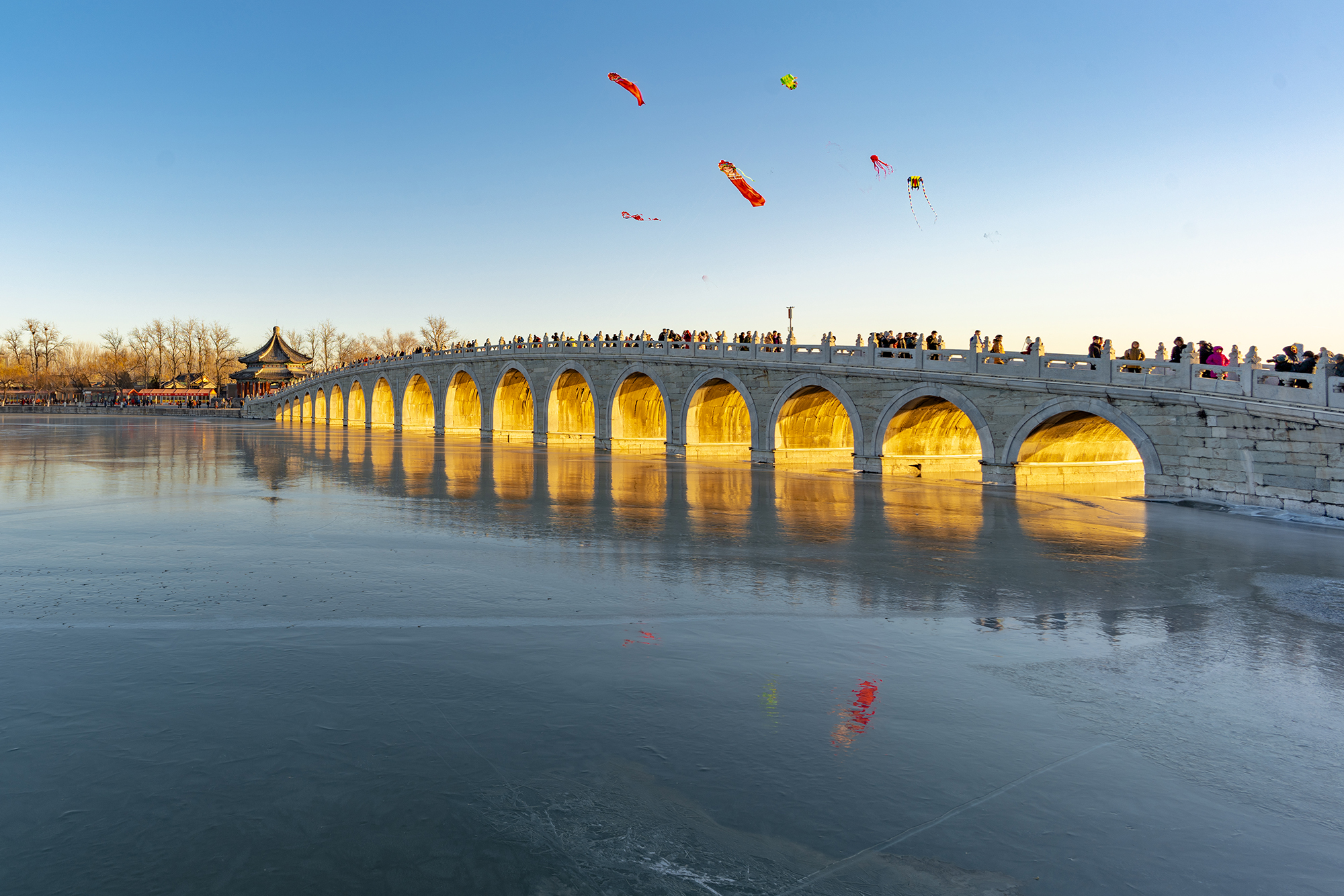 Sunlight shines through the arches of the Seventeen-Arch Bridge at the Summer Palace around the winter solstice in Beijing, China, 2026. /CGTN