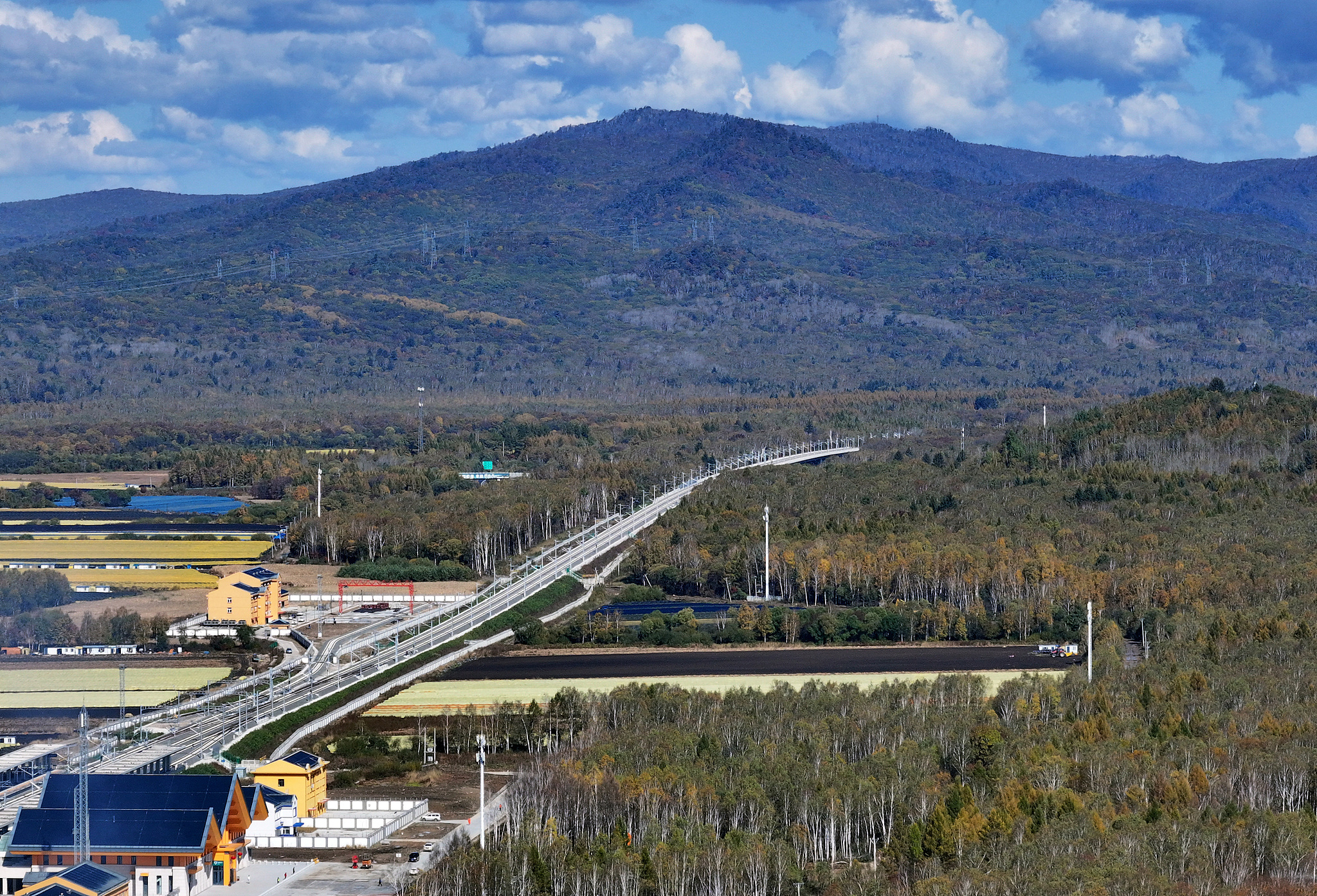 A high‑speed train runs through the autumn forest on the newly‑opened Harbin‑Yichun high‑speed railway in Yichun, Heilongjiang Province, Sept 28, 2026./ VCG
