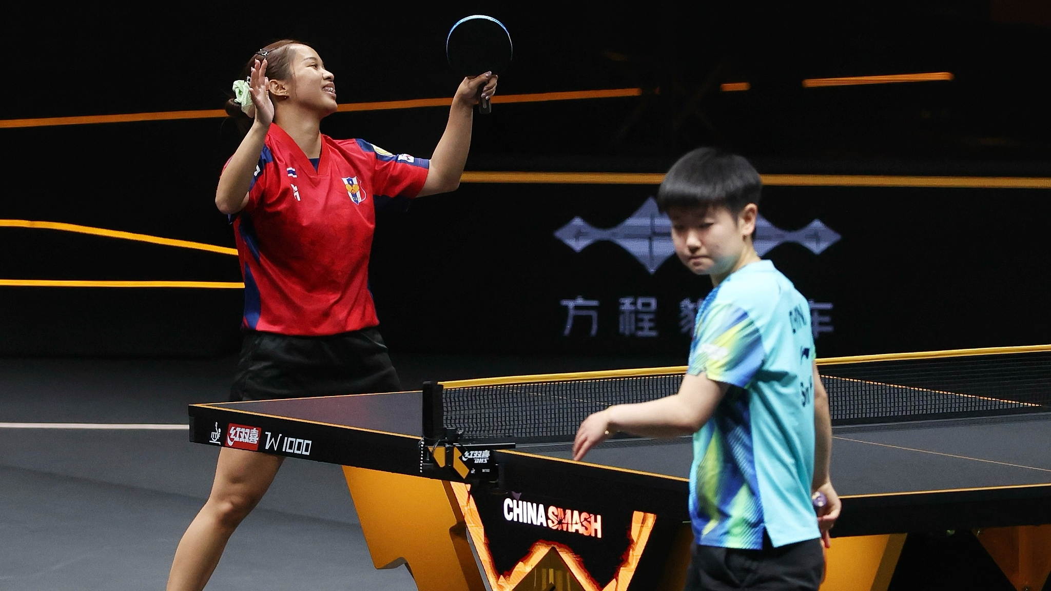 Thailand's Orawan Paranang (L) celebrates after upsetting China's Sun Yingsha in a women's singles match in the round of 32 at the WTT China Smash in Beijing, China, October 7, 2026. /VCG